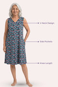 A elder woman wearing a sleeveless knee-length dress with black floral pattern with callout features.