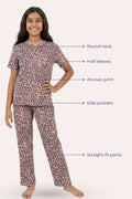 Teen wearing a brown leopard print pajama set with labeled features