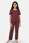 Young girl wearing a wine pajama set