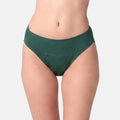 A model wearing a pair of dark green hipster against a light gray studio background.