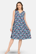 Woman wearing a blue floral aop patterned dress on a white background