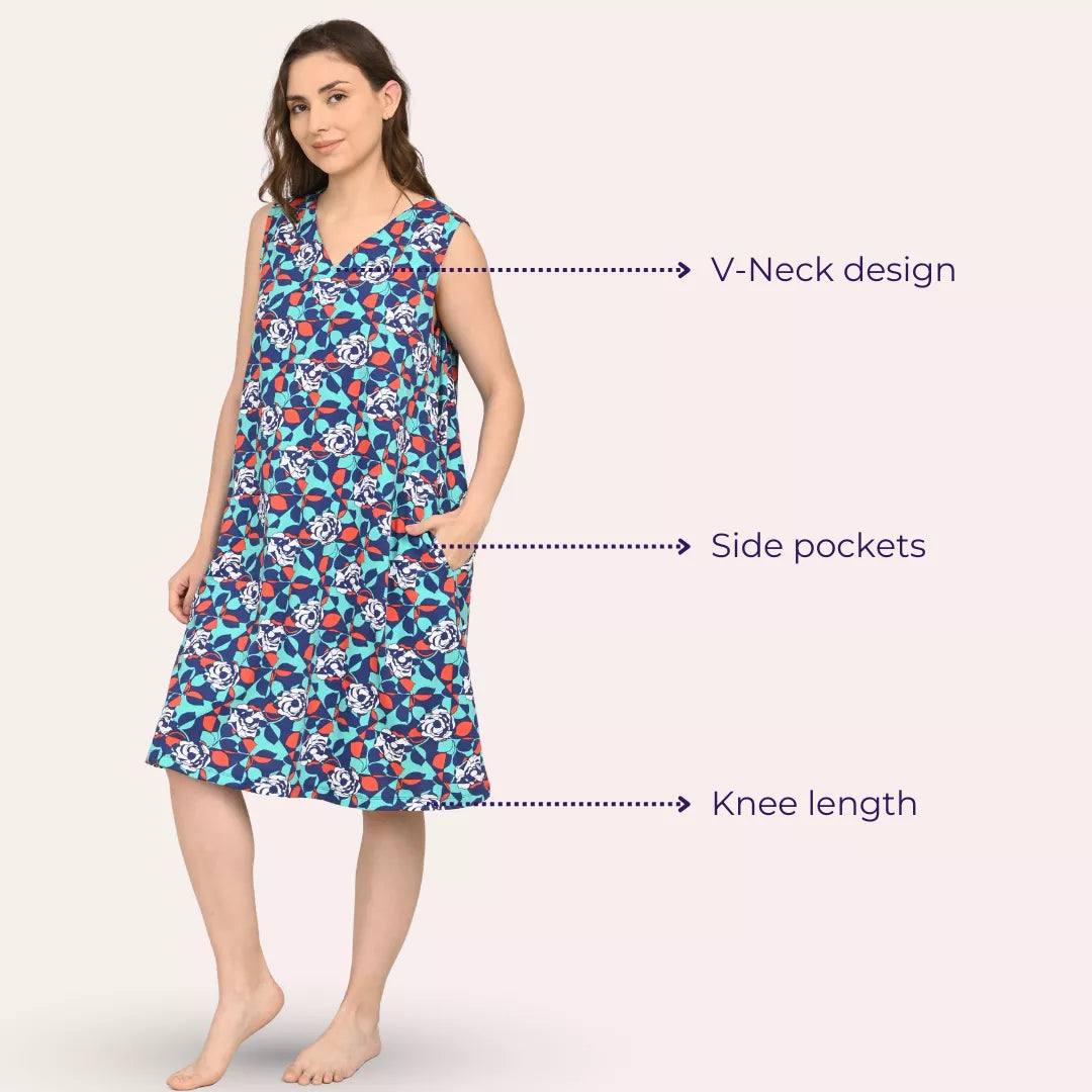 Woman wearing a knee-length dress with V-neck design, side pockets, and blue floral