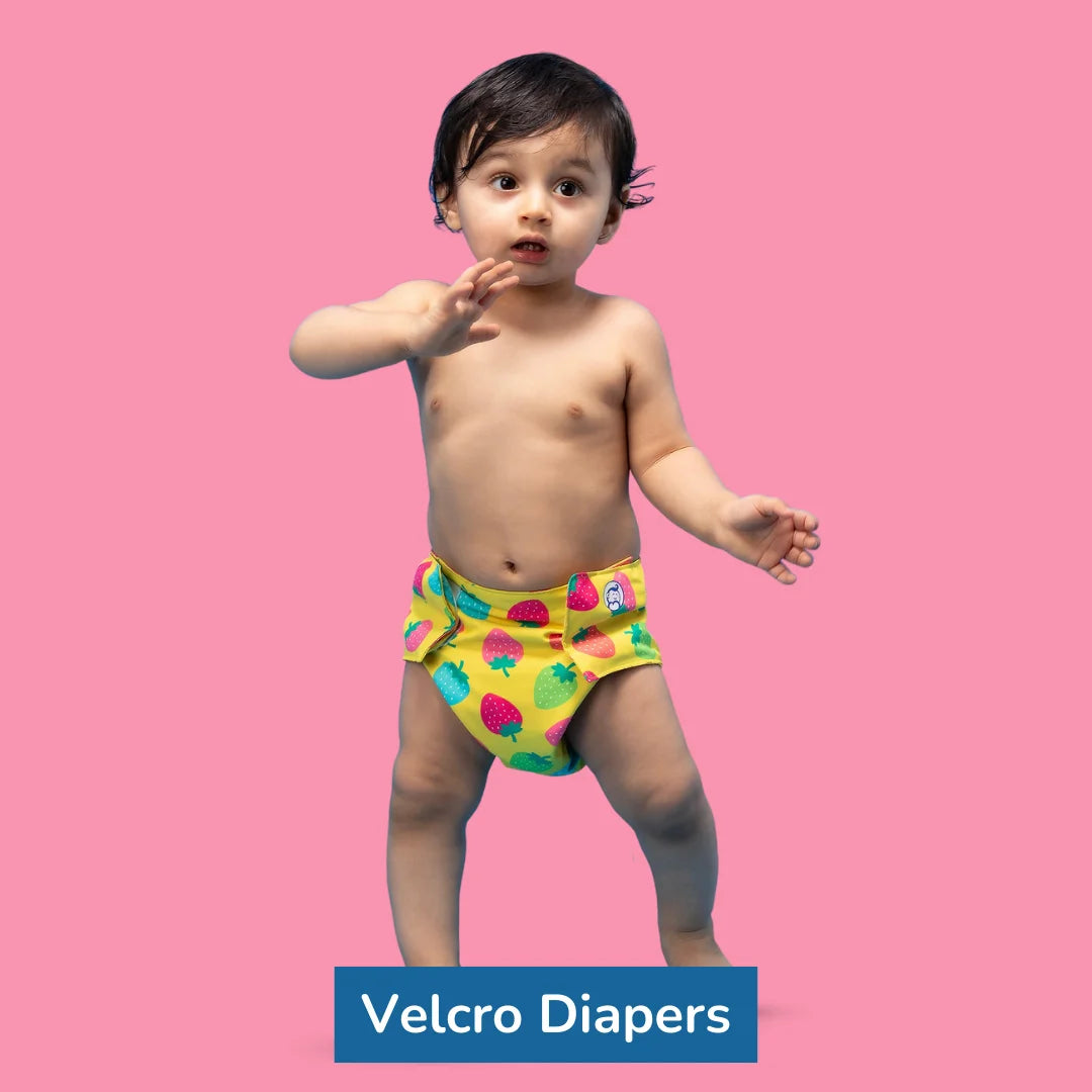 Image of a baby boy wearing a colourful diaper with title of the product inside a blue colour box