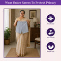Woman wearing a saree with a breathable, skin-friendly, and feather-soft product overlay.