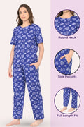 Woman wearing a navy hearts pajama set with heart patterns, surrounded by close-up details