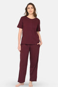 Woman wearing a wine pajama set