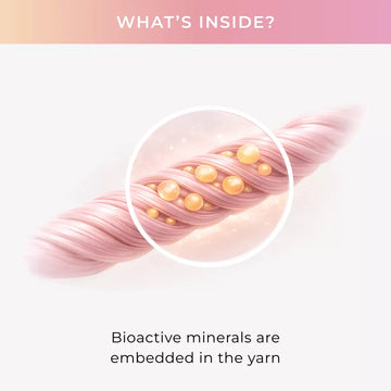 Close-up of pink yarn with embedded bioactive minerals on a light pink background.