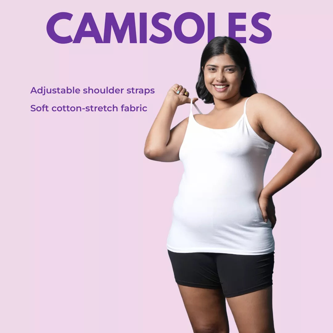 Woman wearing a white camisole with text about adjustable shoulder straps and soft cotton-stretch fabric on a pink background.